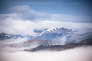 Fototapeta na wymiar Autumn, November foggy and snowy morning mountain panorama.