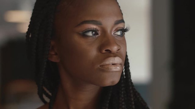Extreme close up of beautiful young african american female fashion model posing indoors and waits for something