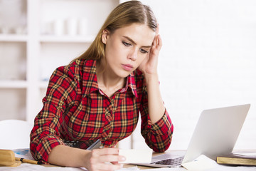 Focused woman looking at business card