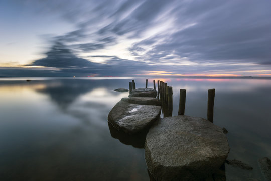 Fototapeta seascape,stone harbor on a calm sea  