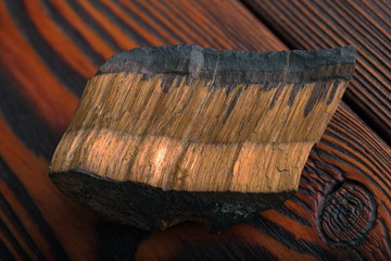 tiger's eye mineral on a dark wooden background