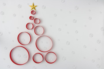 Christmas tree made from ribbon on snowflakes (paper cut). Christmas background.