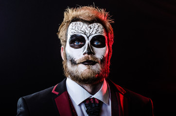 Dead face make up portrait of young man in studio.
