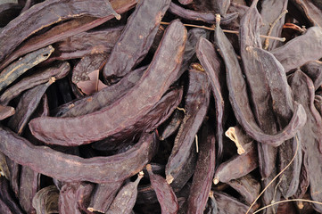 Closeup of carobs in a sack. Agriculture and goods retail