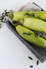Zucchini in a grey box on a white background (close-up)