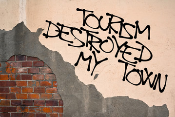 Tourism Destroyed My Town - Handwritten graffiti sprayed on wall, anarchist aesthetics - Locals in touristic destination and their complaint on mass tourism and damage of place by tourists
