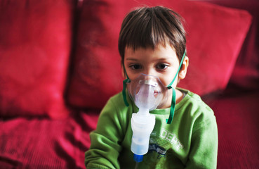 Little boy with aerosols inhaler