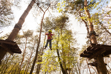 Young boy climbing in a rope park