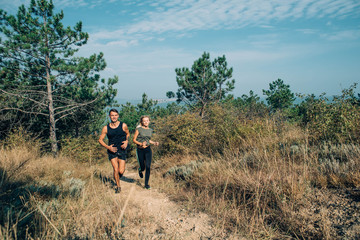 young sporty couple running in the wood 