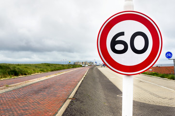 European Speed Limit Sign along a Brick Coastal Road in the Netherlands
