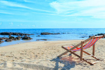 An empty wooden beach chair at the beach