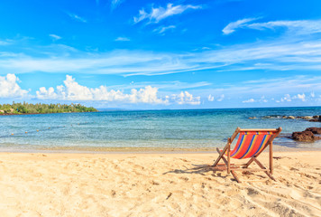 An empty wooden beach chair at the beach