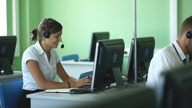 Young businesswoman working in a call center with his colleagues
