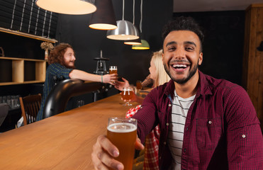 Young People Group In Bar, Hispanic Man Hold Glass Toasting Happy Smiling, Friends Sitting At Wooden Counter Pub