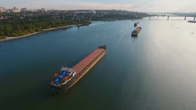 Cargo ship in green river water. Aerial view.