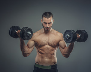 Obraz na płótnie Canvas Male doing biceps workouts with dumbbells.