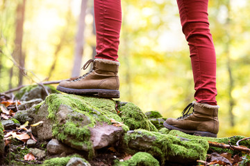 Close up of legs of unrecognizable woman in autumn nature