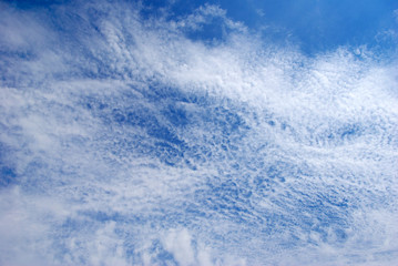 Blue sky background with tiny clouds