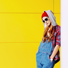 Stylish Urban girl in shirt and jeans overalls