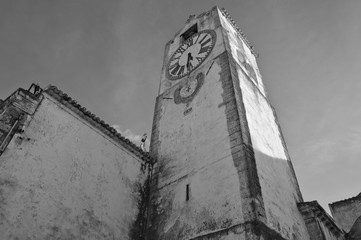 Black and white photograph of the Church of Saint Mary (Igreja de Santa Maria do Castelo) in Tavira, Algarve, Portugal