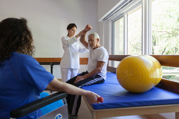 Adult people doing a physical rehabilitation