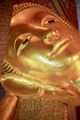 Face of Reclining Buddha,and thai art architecture in Wat Phra Chetupon Vimolmangklararm (Wat Pho) temple in Thailand.