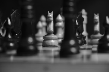Black and white close-up photograph of a game of chess