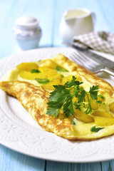 Omelet stuffed with potato and cheese.