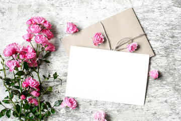 Bouquet of roses with a blank greeting card and envelope