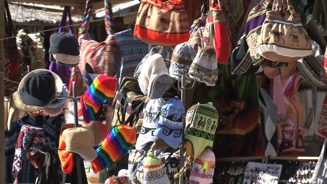 Chullos and bags at a typical Peruvian market in Ollantaytambo