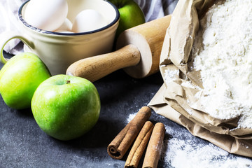 The ingredients for apple pie on a black background, selective focus, horizontal