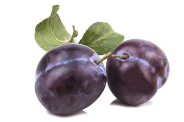 Two connected blue sweet ripe plums
