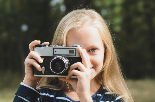 Cute little girl with a vintage rangefinder camera.