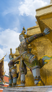 The beautiful of giants  statue under golden pagoda of the Emerald Buddha temple(Wat phra kaew) and Royal Grand Palace ,Bangkok,Thailand.