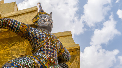 The special of giants statue with elephant trunk under golden pagoda of Emerald Buddha temple(Wat phra kaew) and Royal Grand Palace ,Bangkok,Thailand.