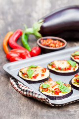 Baked  eggplant with cheese and tomatoes on baking tray