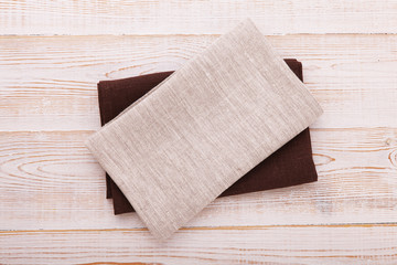 Napkin. Cloth napkin on white wooden background. Top view, mock up.