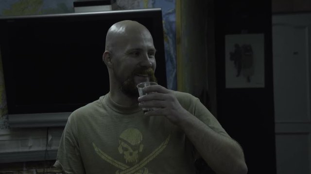 Bald man in a T-shirt with a skull says. The bearded guy with a pirate on the chest says