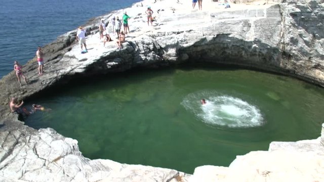Boy jumps in to Giola, Natural Pool, Thassos Greece