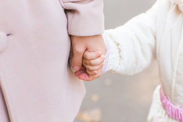 Child holding mother's hand