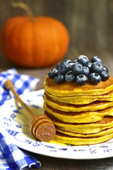 Pumpkin pancakes with fresh blueberry and honey.