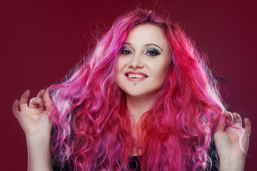 Attractive woman with pink hair in witch image. Halloween style