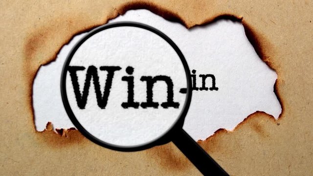 Magnifying glass on win text