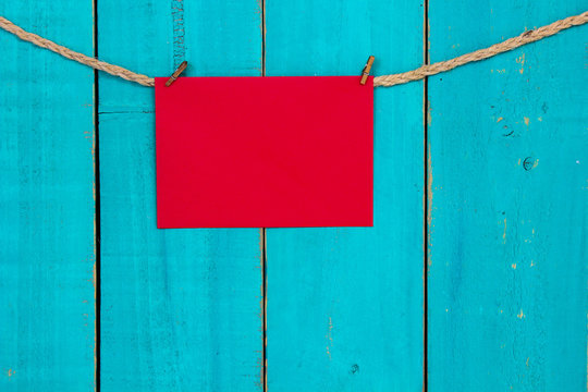 Blank red sign hanging on rope