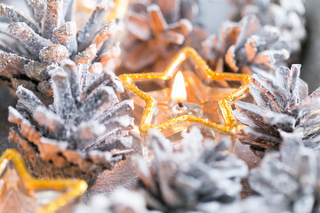 Christmas. Christmas card with glowing small candle and fir cone