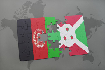 Obraz premium puzzle with the national flag of afghanistan and burundi on a world map background.