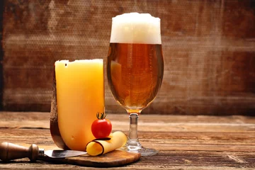 Foto auf Leinwand Yellow cheese appetizer and beer © wideonet
