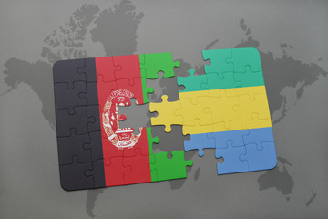 puzzle with the national flag of afghanistan and gabon on a world map background.