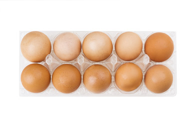Brown eggs in the plastic box over white