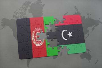 puzzle with the national flag of afghanistan and libya on a world map background.